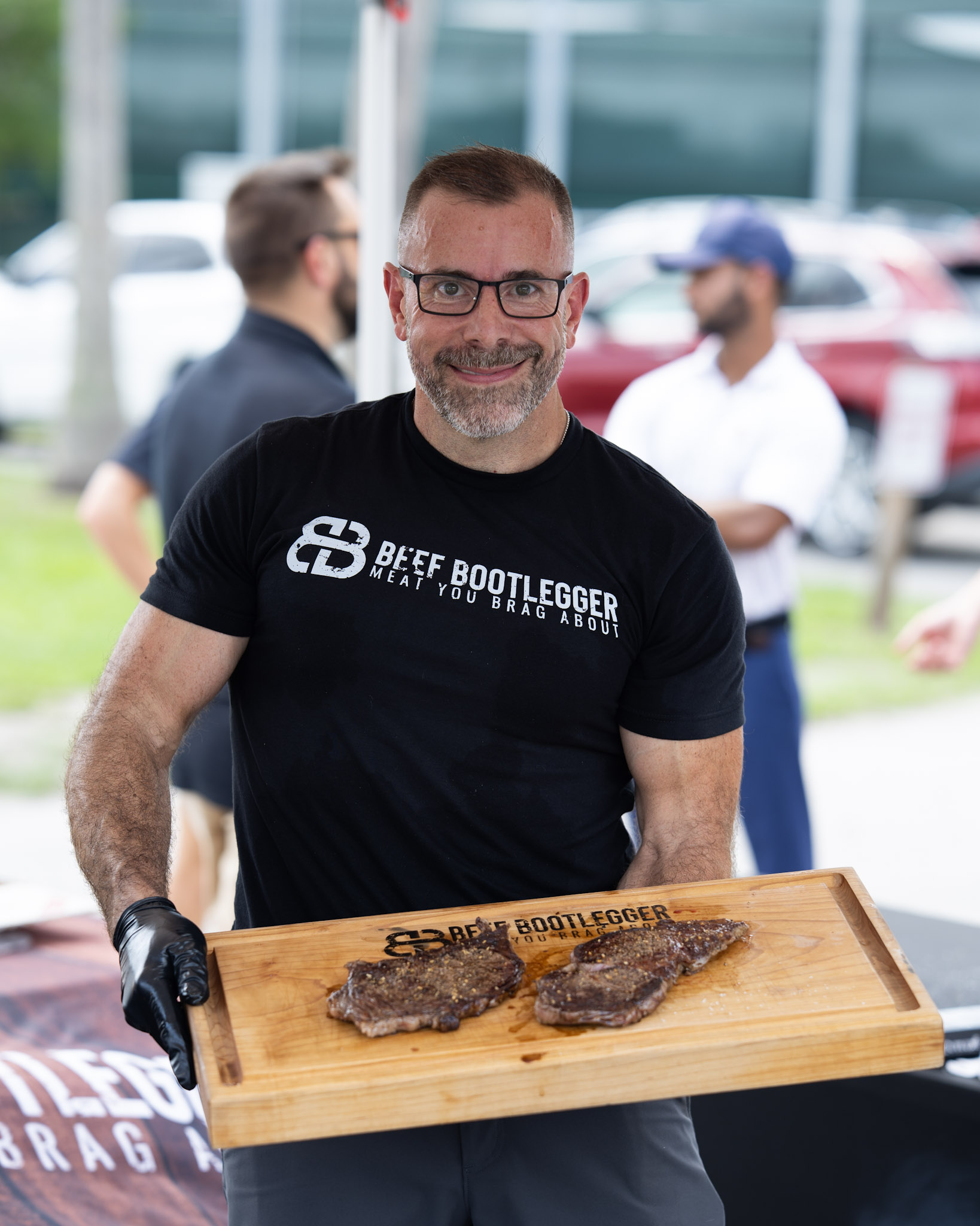 Beef Bootlegger welcoming guests with a board of steak